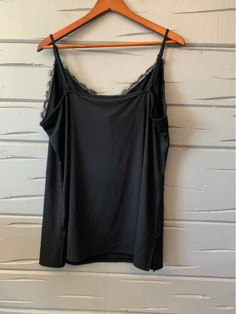Black lace-trimmed women's casual top with thin straps hanging on wooden hanger.