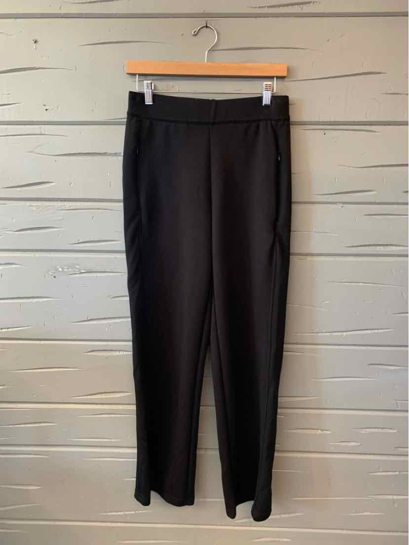 Black Ellie Tahari straight-leg trousers with a smooth finish and tailored waistband, hung against a white wall.