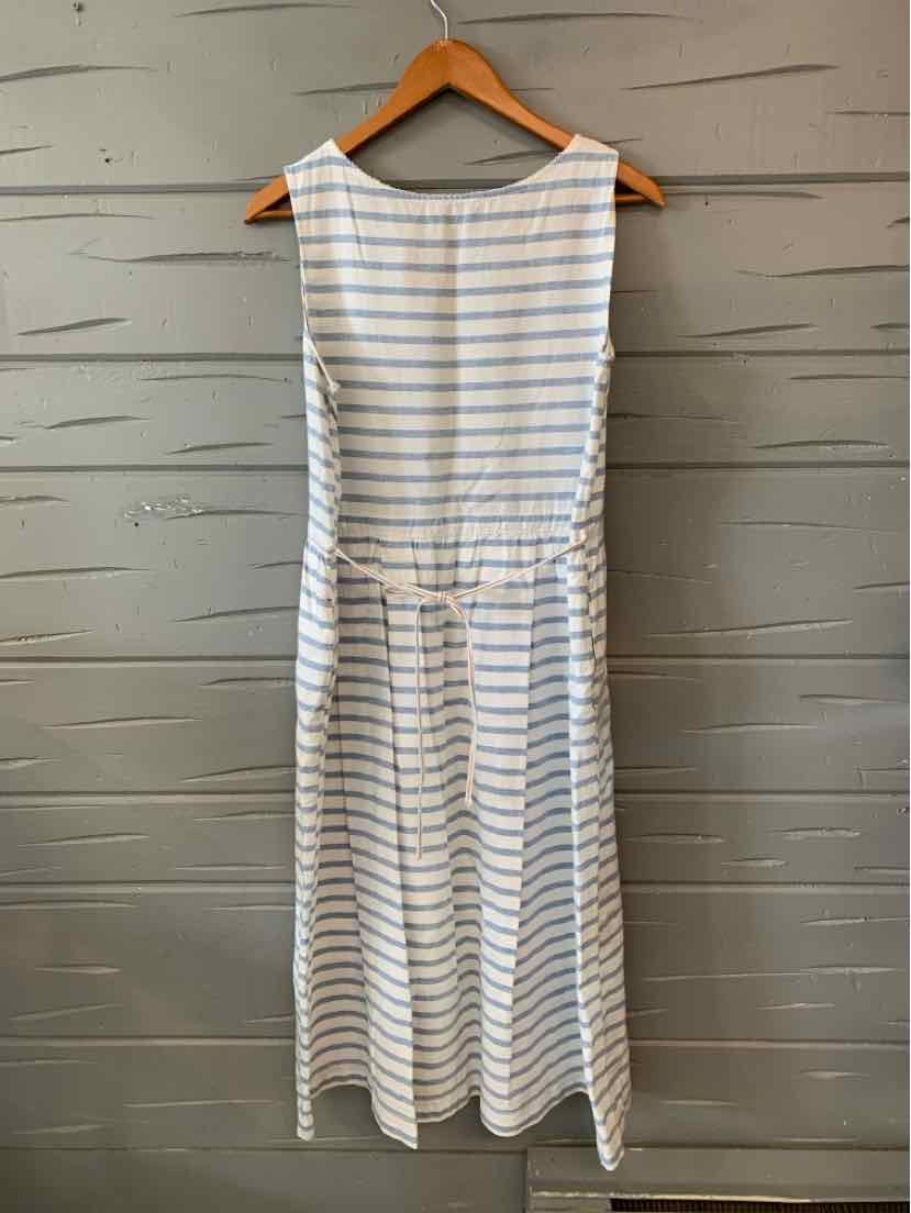 Sleeveless white dress with thin blue horizontal stripes and a cinched waist hanging on wooden hanger.