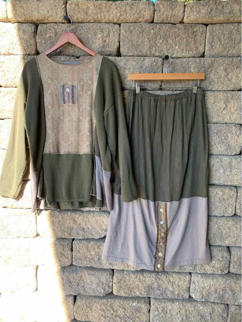 Two-piece olive green lounge set with a patterned knit-front top and matching color-block pants with pale gray cuffs.