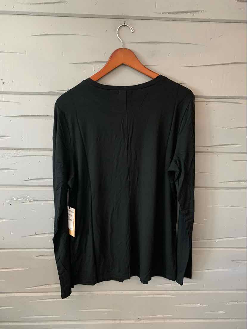 Black long-sleeve solid shirt in XL size with crew neckline hanging on wooden hanger against gray wall.