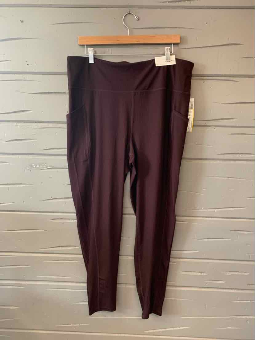 Burgundy solid leggings in size XXL with a high waistband, displayed on a wooden hanger against a light gray wall.