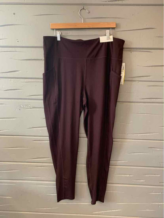 Burgundy solid leggings in size XXL with a high waistband, displayed on a wooden hanger against a light gray wall.