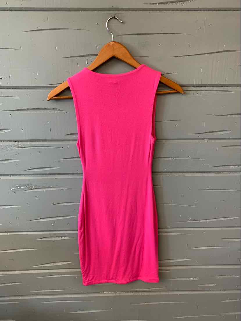 Sleeveless bright pink fitted mini dress on wooden hanger against gray textured wall.