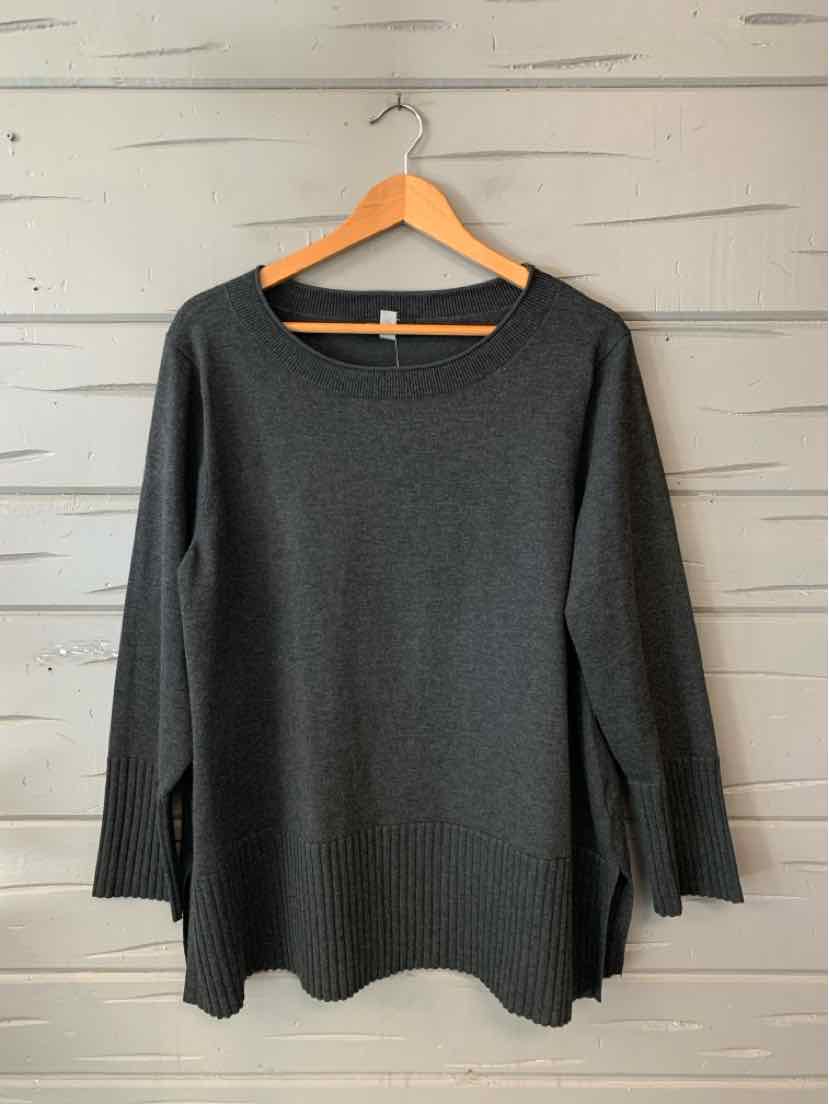 Dark gray cable knit sweater with long sleeves and ribbed cuffs, displayed on wooden hanger.