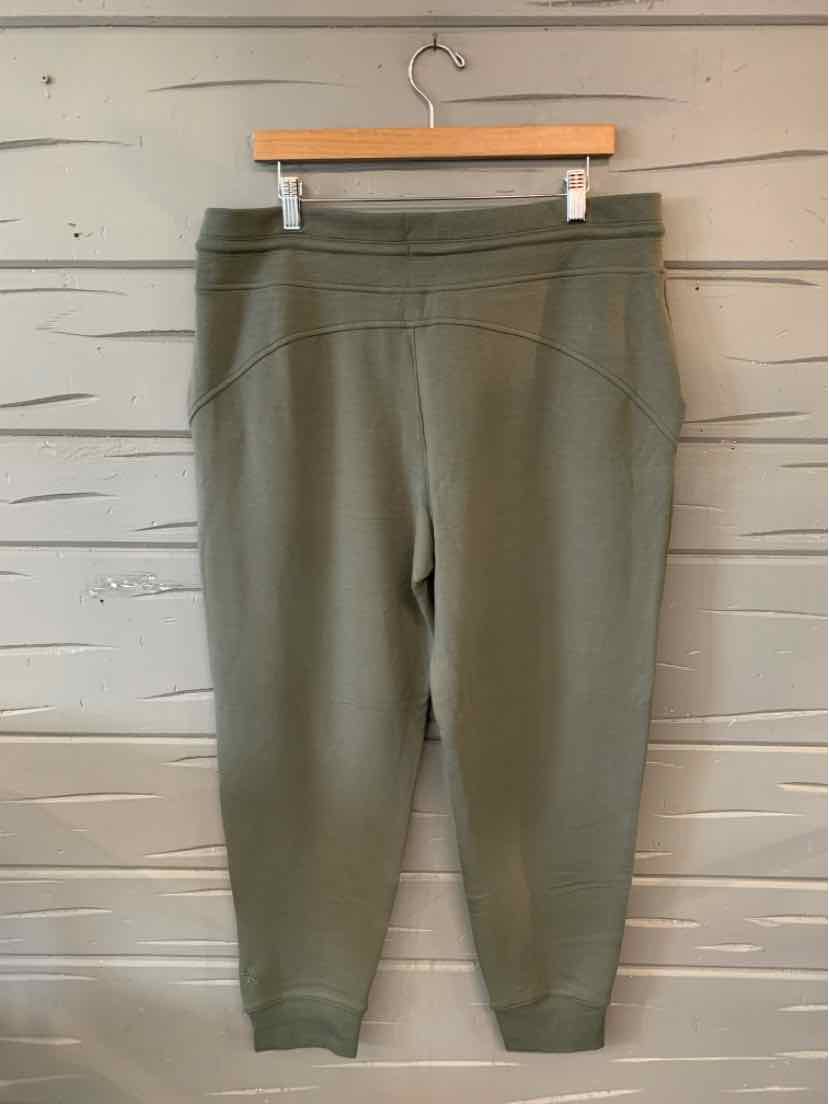 Olive green high-waist jogger pants with elastic waistband and cuffed ankles, size XL.