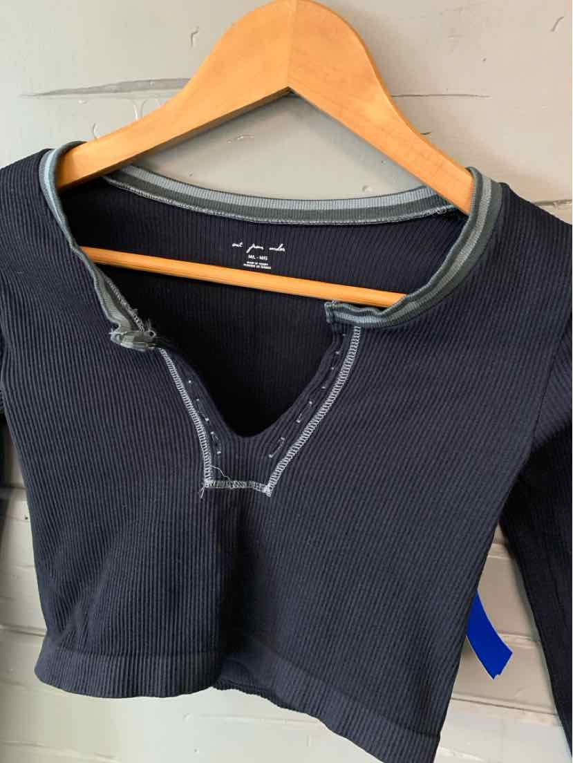 Black cropped short-sleeve top with a deep V neckline and contrast gray stitching.
