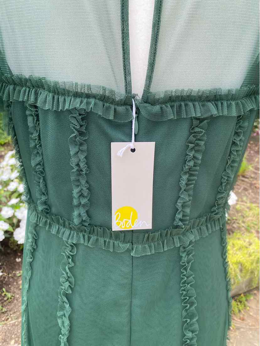 Green sleeveless dress with ruffled trim details along the bodice edges and a fitted waist.