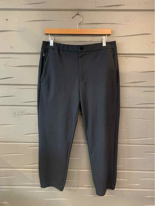 Women’s dark gray Theory trousers with a slim straight-leg fit, waistband button, and side pockets.