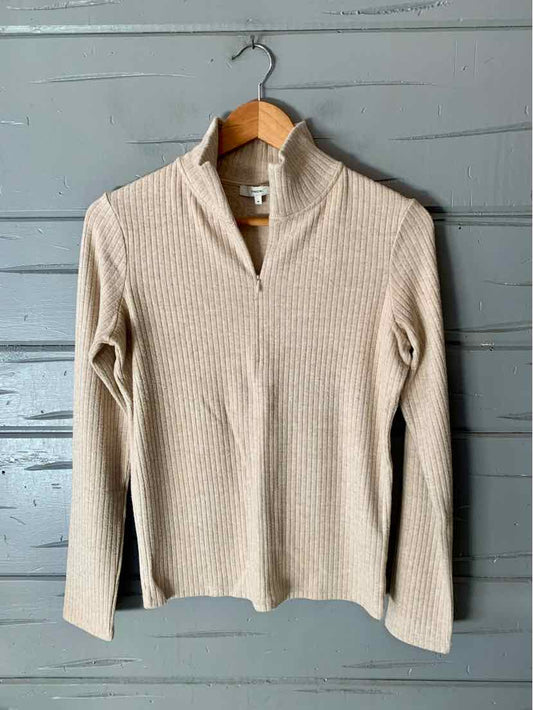 Cream ribbed-knit long-sleeve sweater with a split V-neck and fitted silhouette.