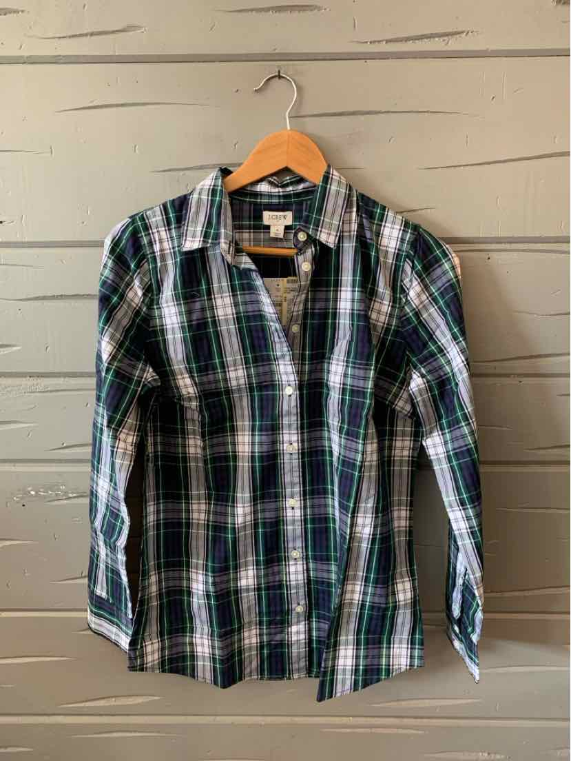 Long-sleeve button-up shirt with green, navy, white, and black plaid pattern on cotton fabric.