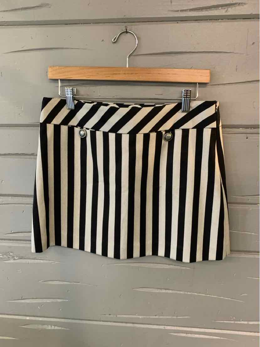 Black and white vertical striped mini skirt with diagonal stripe waistband and button detail, size 6.