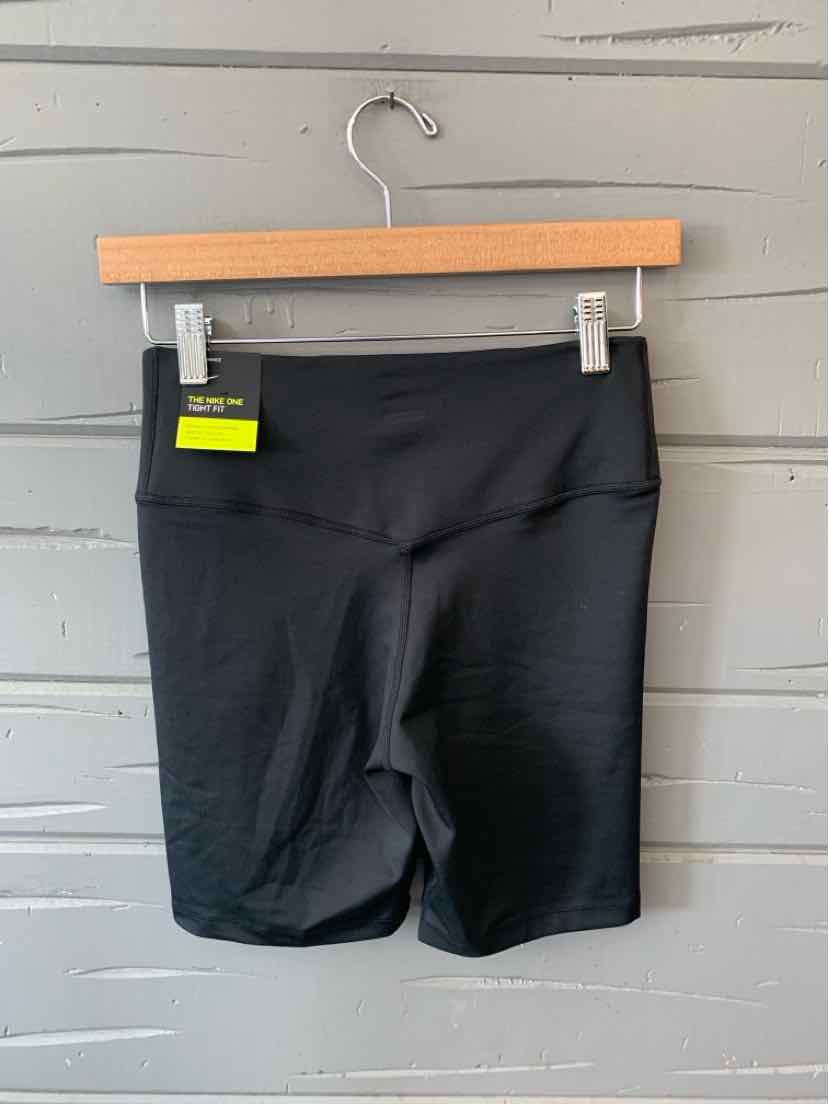 Black high-waisted Nike athletic shorts with smooth fabric and a small green tag on the waistband.
