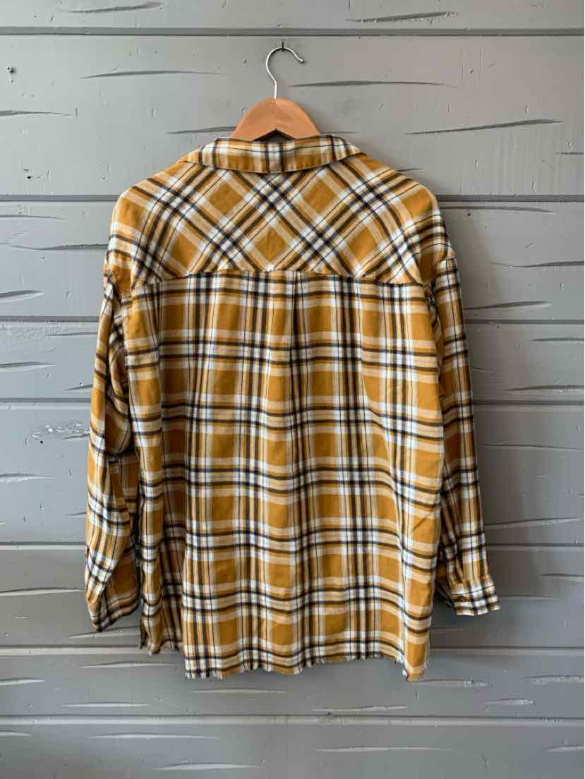 Yellow and white plaid flannel shirt with long sleeves and a pointed collar hanging on wooden hanger.