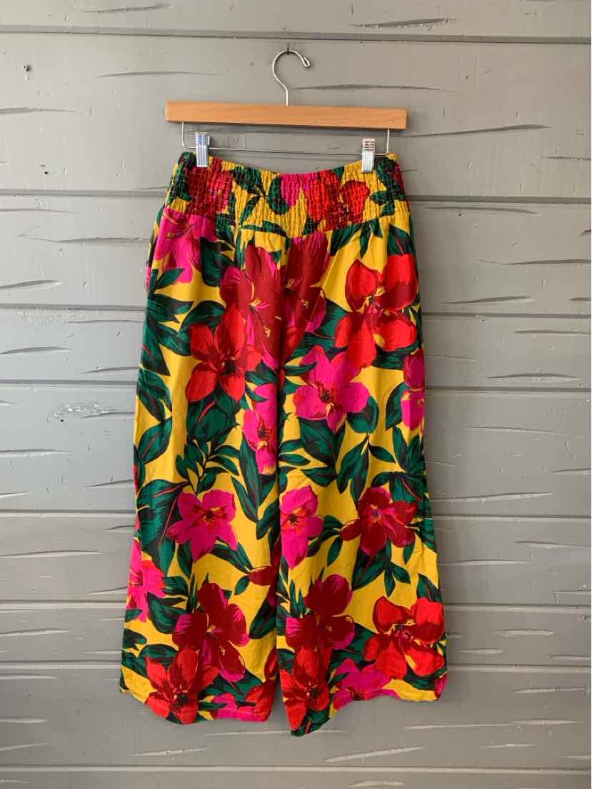 Yellow wide-leg pants with vibrant red and pink floral print and green leaves, elastic waistband.