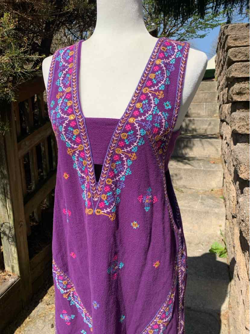 Purple sleeveless dress with deep V-neck and colorful geometric embroidery on front and shoulders.