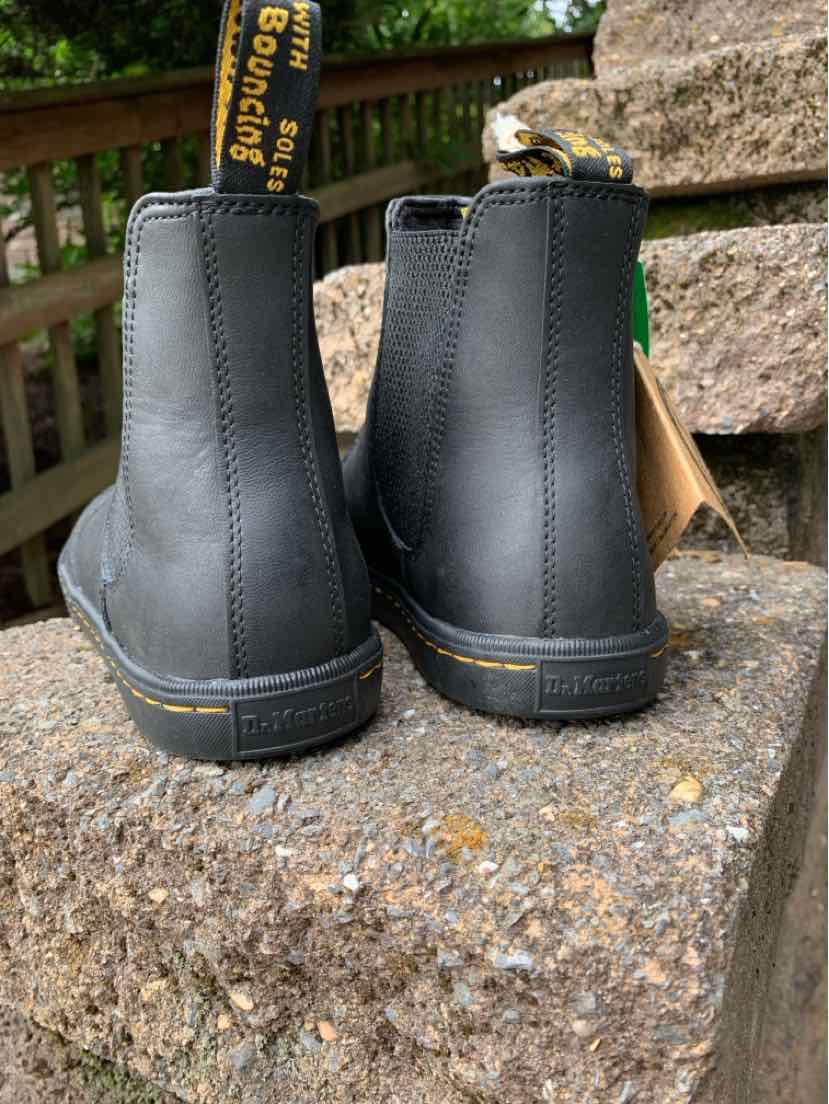 Black leather Dr. Martens boots size 7 with yellow stitching and branded pull tabs, rear view.