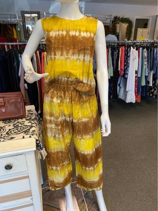 Yellow and brown tie-dyed sleeveless jumpsuit with cinched waist and wide legs in medium size.