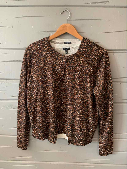 Tan and black cheetah print cardigan with round neckline and long sleeves on wooden hanger.
