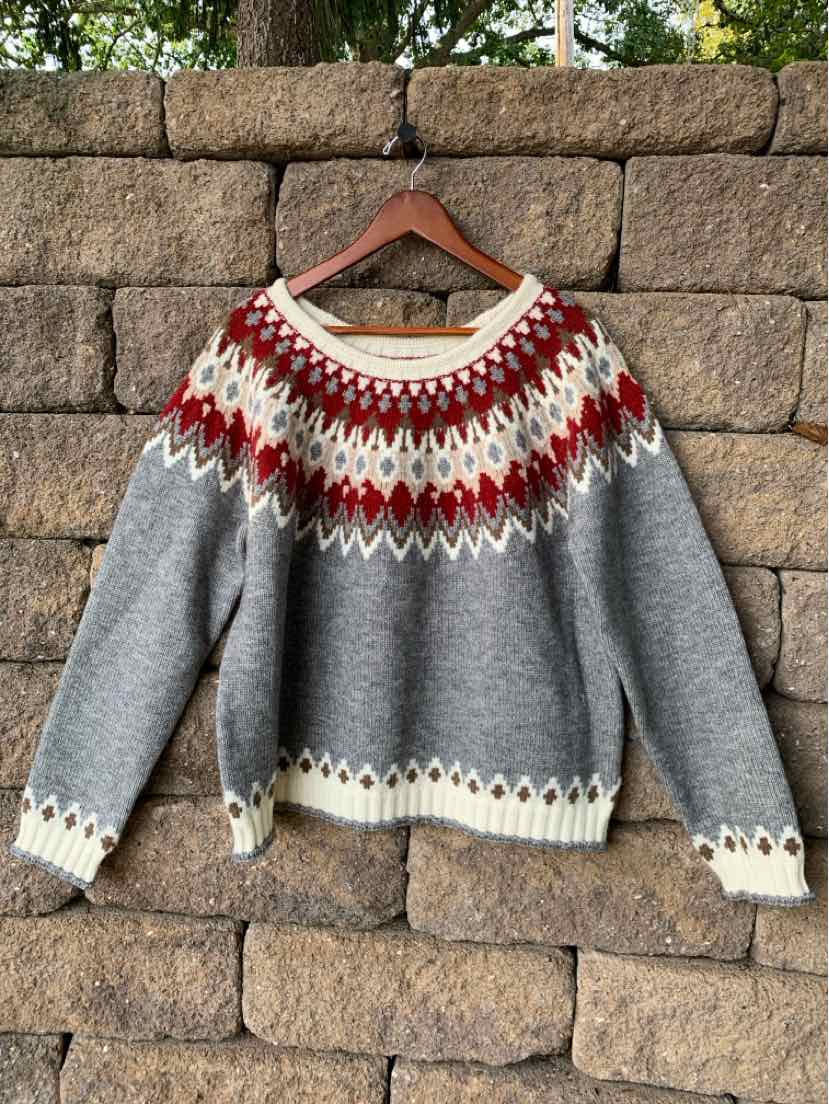 Gray wool sweater with a red, white, and cream Fair Isle yoke and matching trim at the cuffs and hem.
