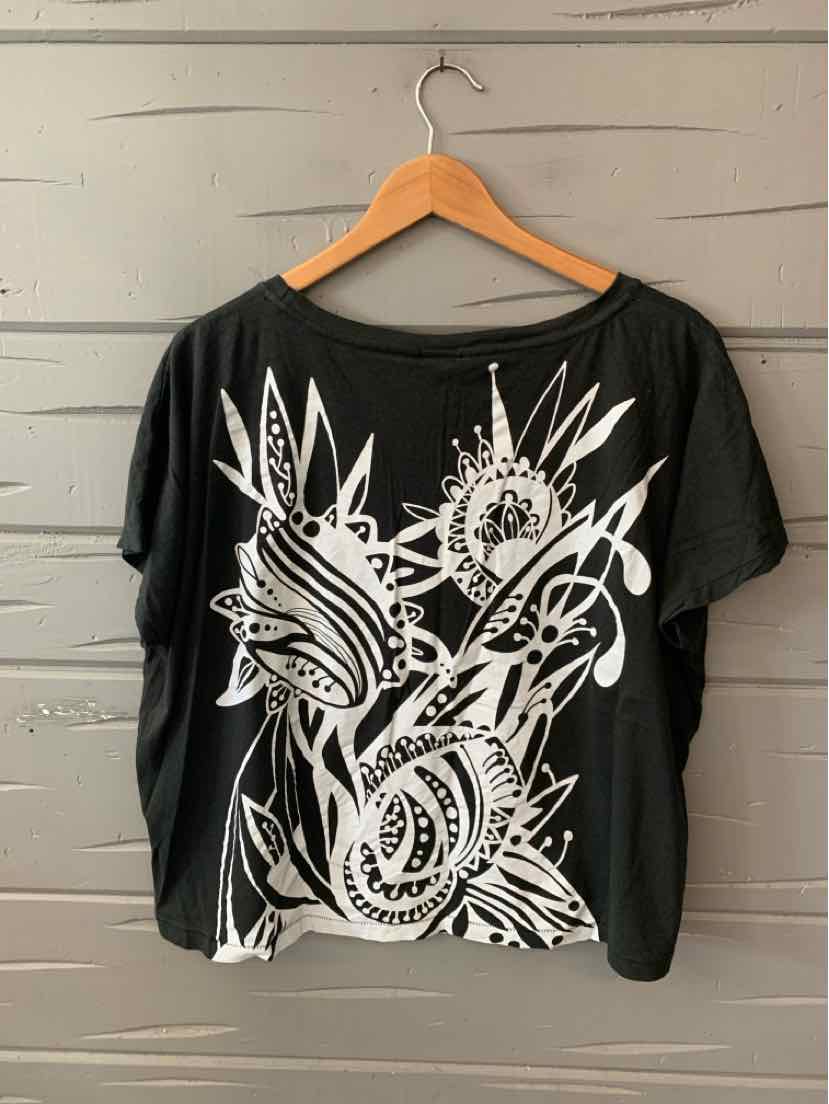 Black short-sleeve t-shirt with large white abstract floral and geometric graphic on front, loose fit, round neckline.