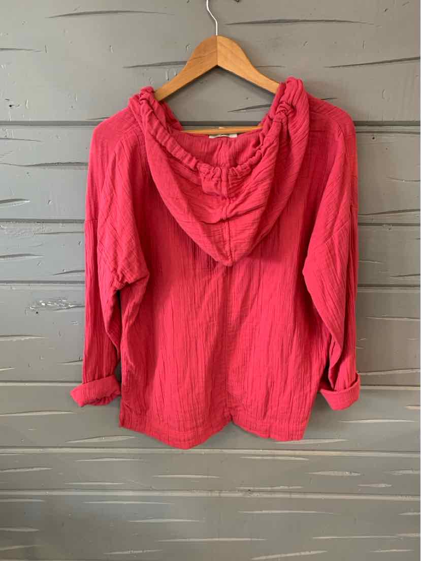 Red hooded lightweight jacket with long sleeves and casual fit, hanging on wooden hanger.