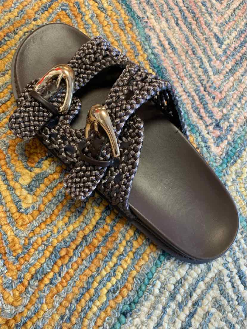 Black woven slide sandal with double straps and silver buckle accents, size 10.