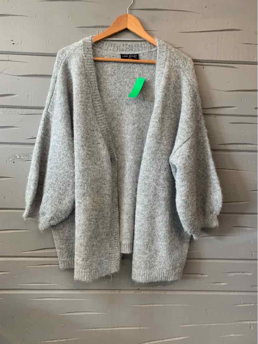Light gray open-front cardigan with long balloon sleeves, soft knit fabric, relaxed fit, hanging on wooden hanger against.