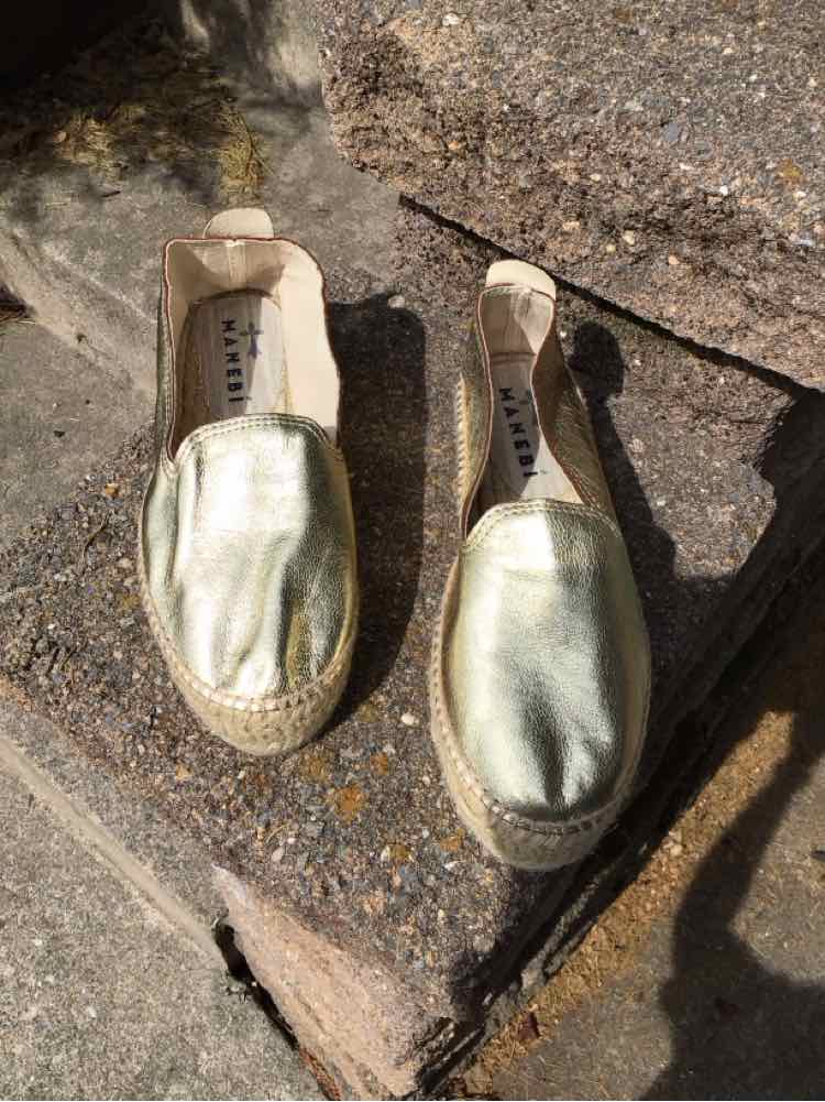 Gold metallic slip-on espadrilles with braided jute soles and beige fabric trim, size 38.