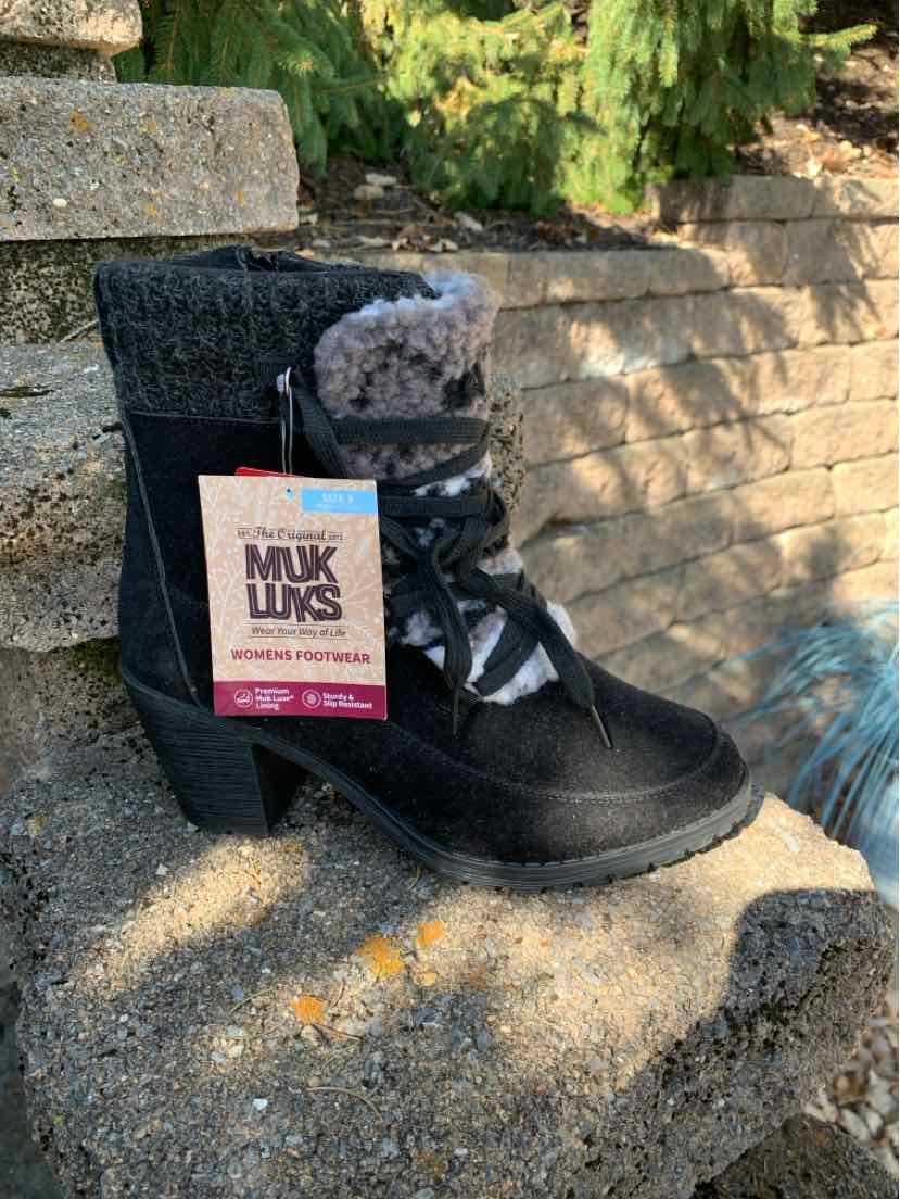 Black suede MUK LUKS ankle boot with plush gray lining, rounded toe, and side lace detail.
