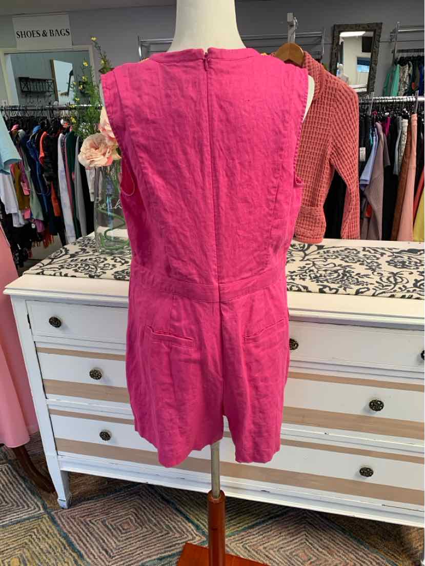 Pink sleeveless romper with back zipper and tailored seams on mannequin.