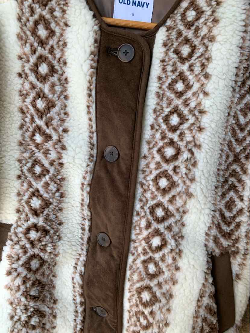 Brown and cream knit cardigan with geometric patterns and brown buttons.