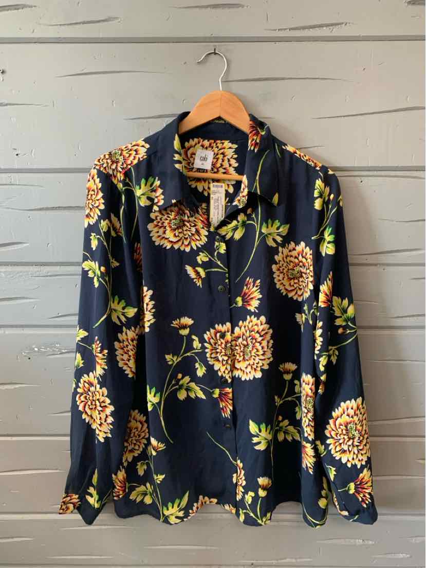 Black long-sleeve blouse with yellow and orange floral print, collared neckline, and button-up front.