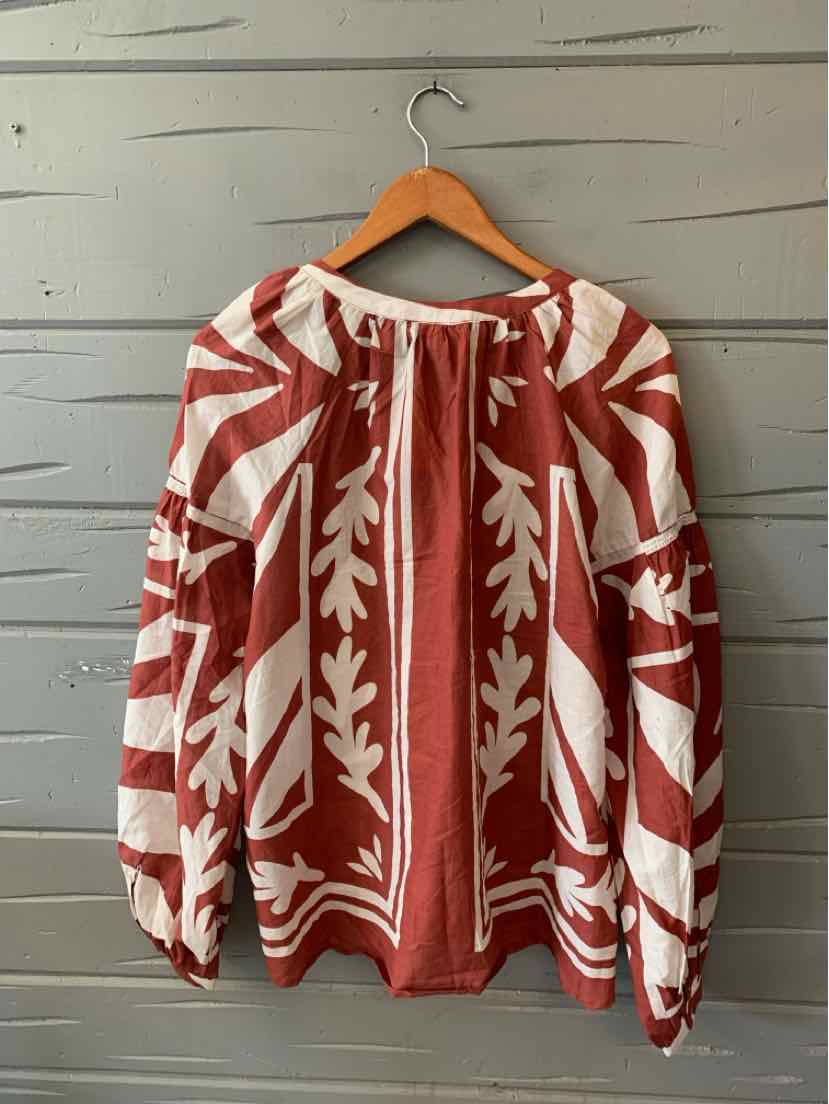 Red and white patterned long-sleeve blouse with loose fit and gathered neckline.