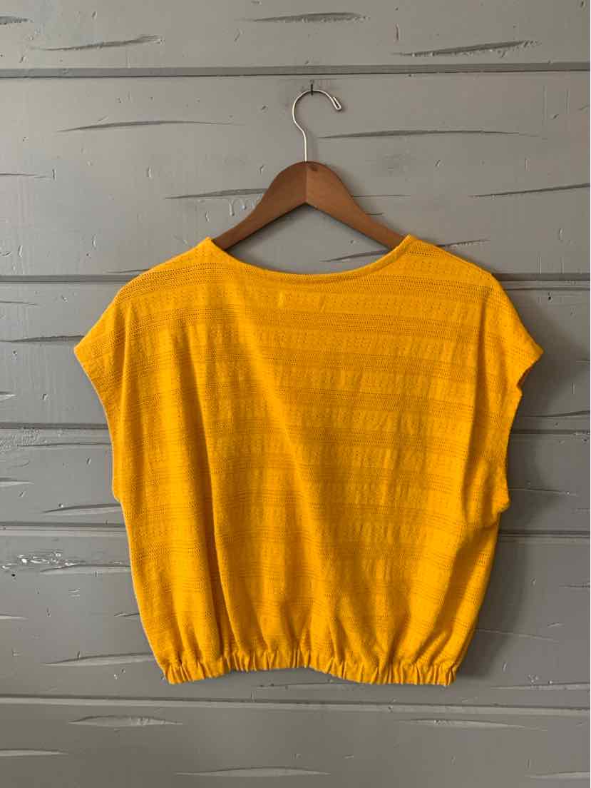 Bright yellow short-sleeve blouse with a round neckline and elasticated hem on a wooden hanger.