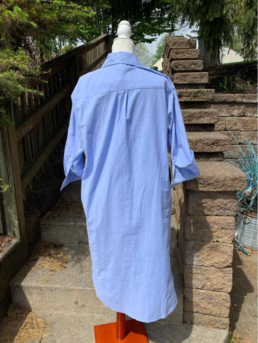 Light blue long shirt dress with collar and three-quarter sleeves on white mannequin outdoors.