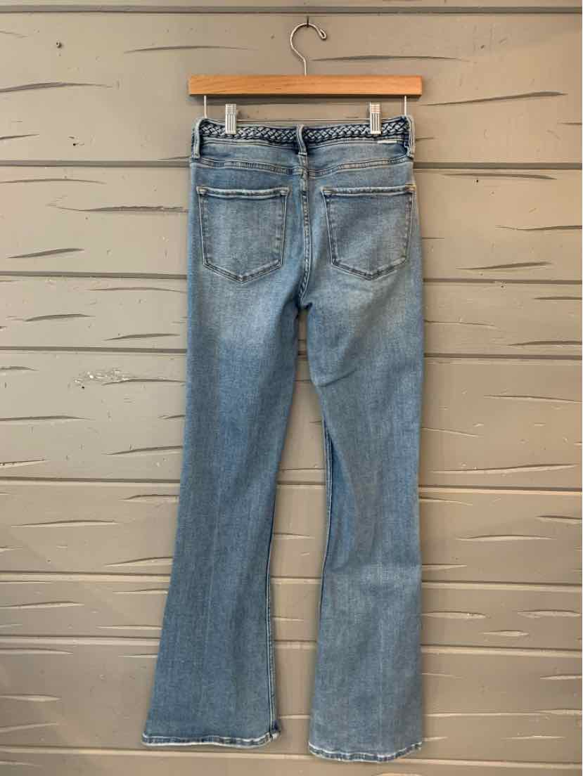 Light blue denim jeans with a slight flare and two back pockets hanging on a wooden hanger.