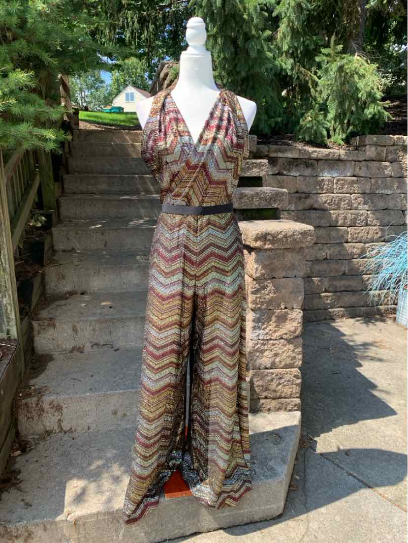 Metallic multicolor chevron jumpsuit with short sleeves and wide legs on white mannequin.