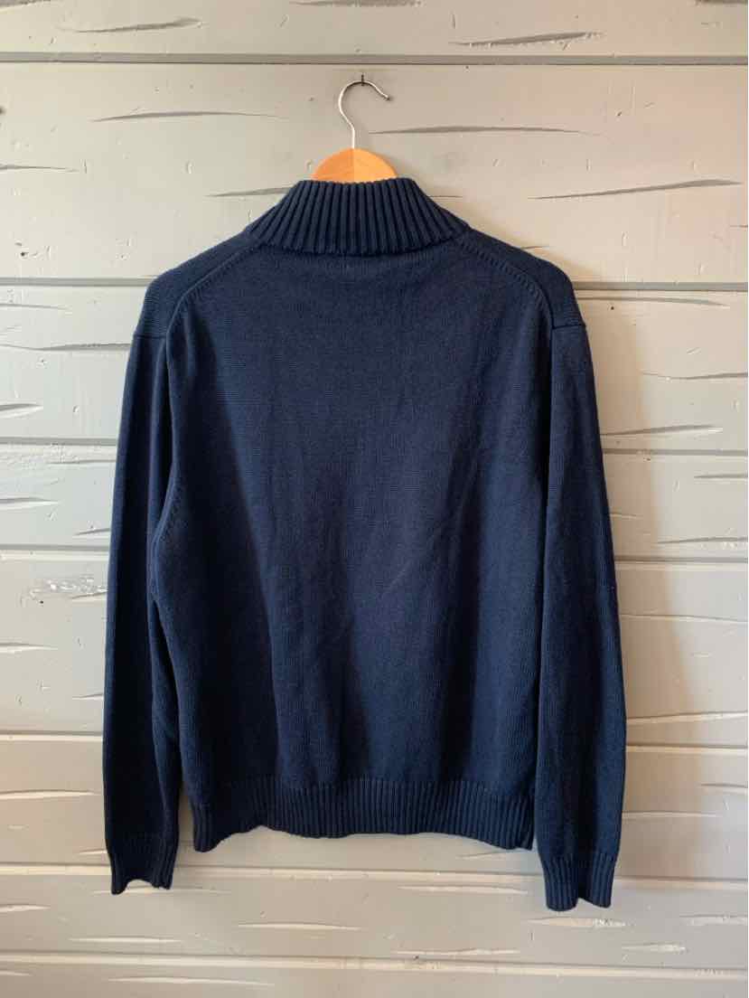 Navy blue long-sleeve knit sweater with ribbed collar and cuffs, hanging on wooden hanger.