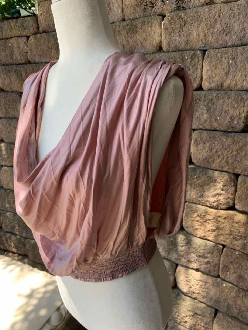 Dusty pink sleeveless blouse with deep V-neck and gathered waist band in lightweight fabric.