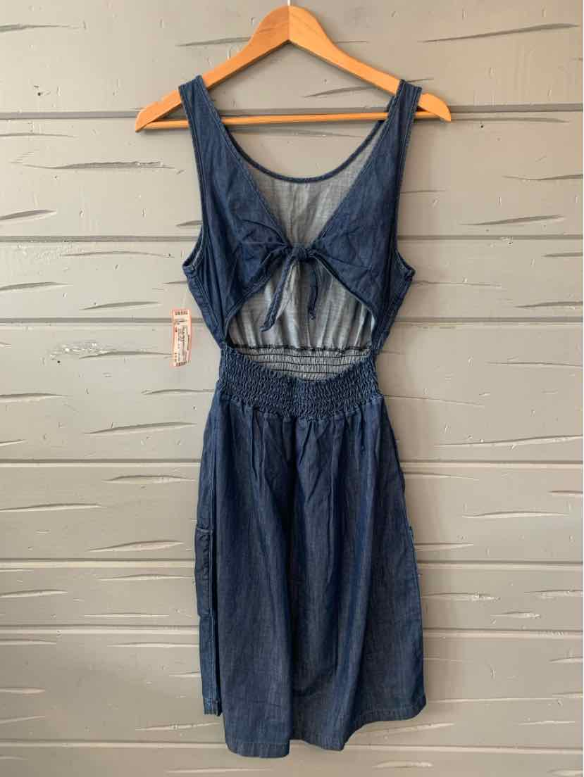 Sleeveless navy blue dress with deep scoop neckline and smocked waist, lightweight fabric.