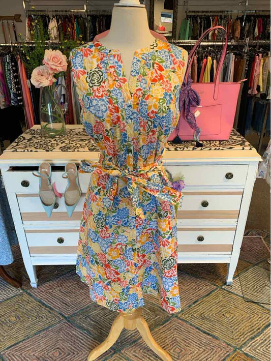 Sleeveless floral dress with multicolor print, tie belt waist, and knee-length hem.