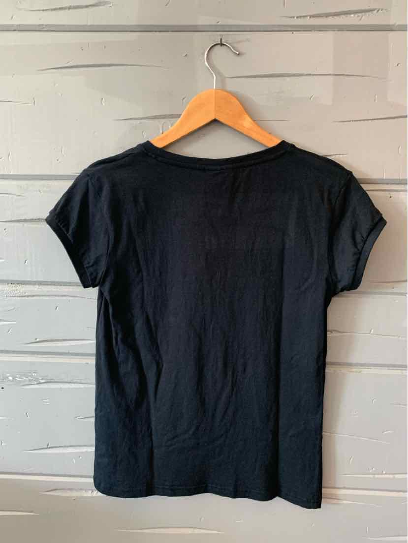 Black short-sleeve cotton T-shirt with crew neck, displayed on wooden hanger against gray textured wall.
