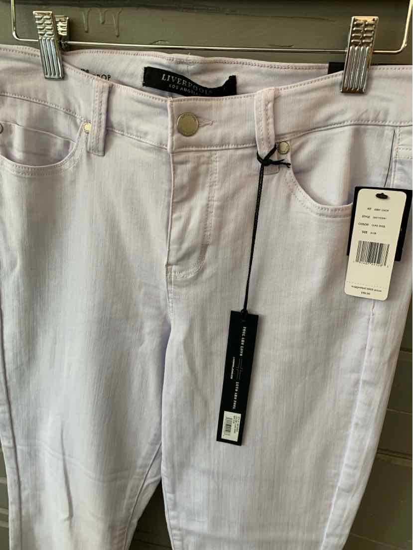 Light lavender solid slim-fit jeans with gold-button closure and front pockets, size 6.